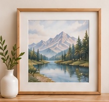 Framed mountain lake painting beside a small vase